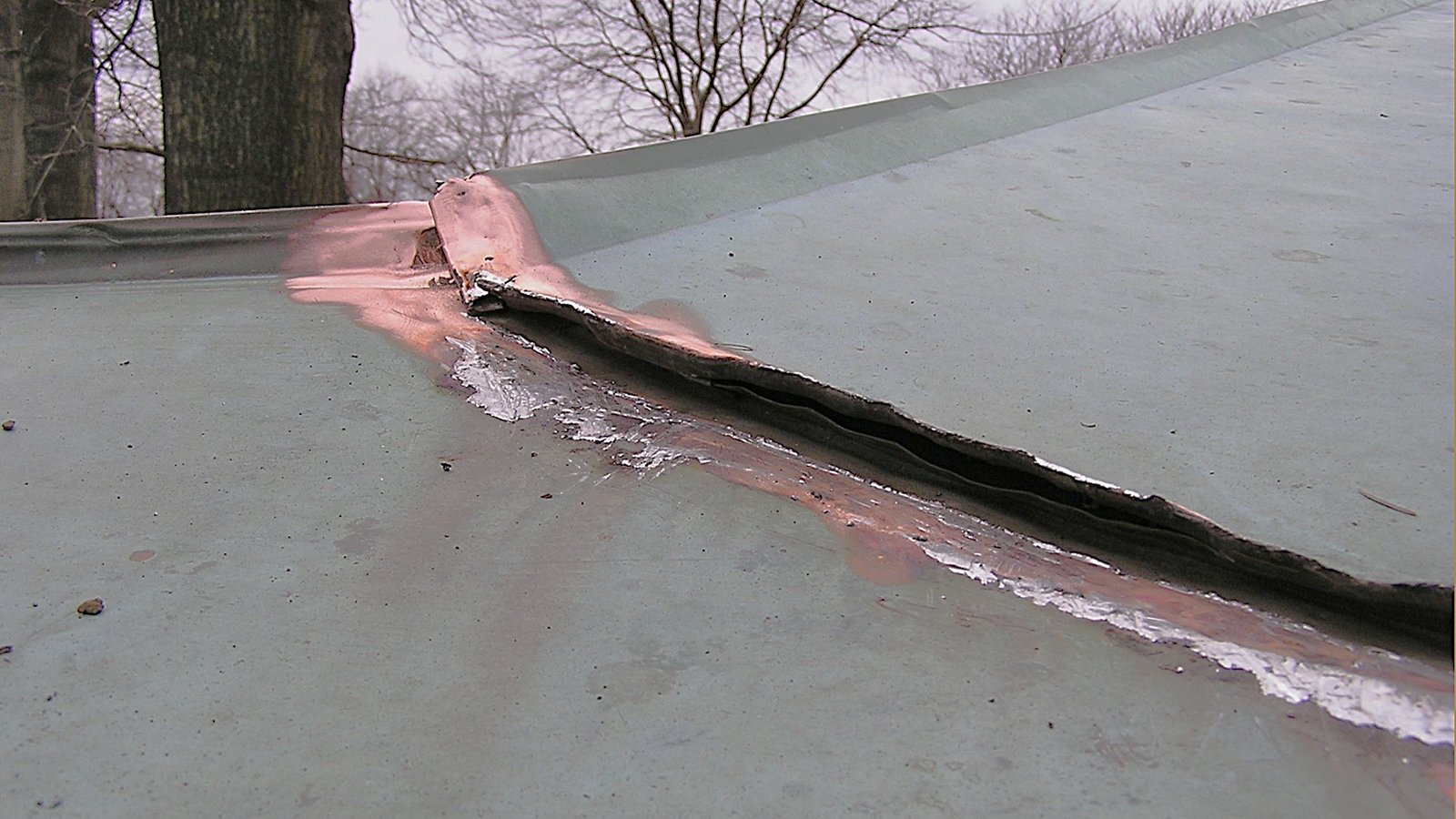 Copper flat seam opened for dirt and solder removal during repair 