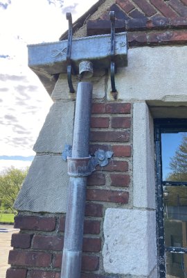 Historic lead downspout and ornamental wall bracket